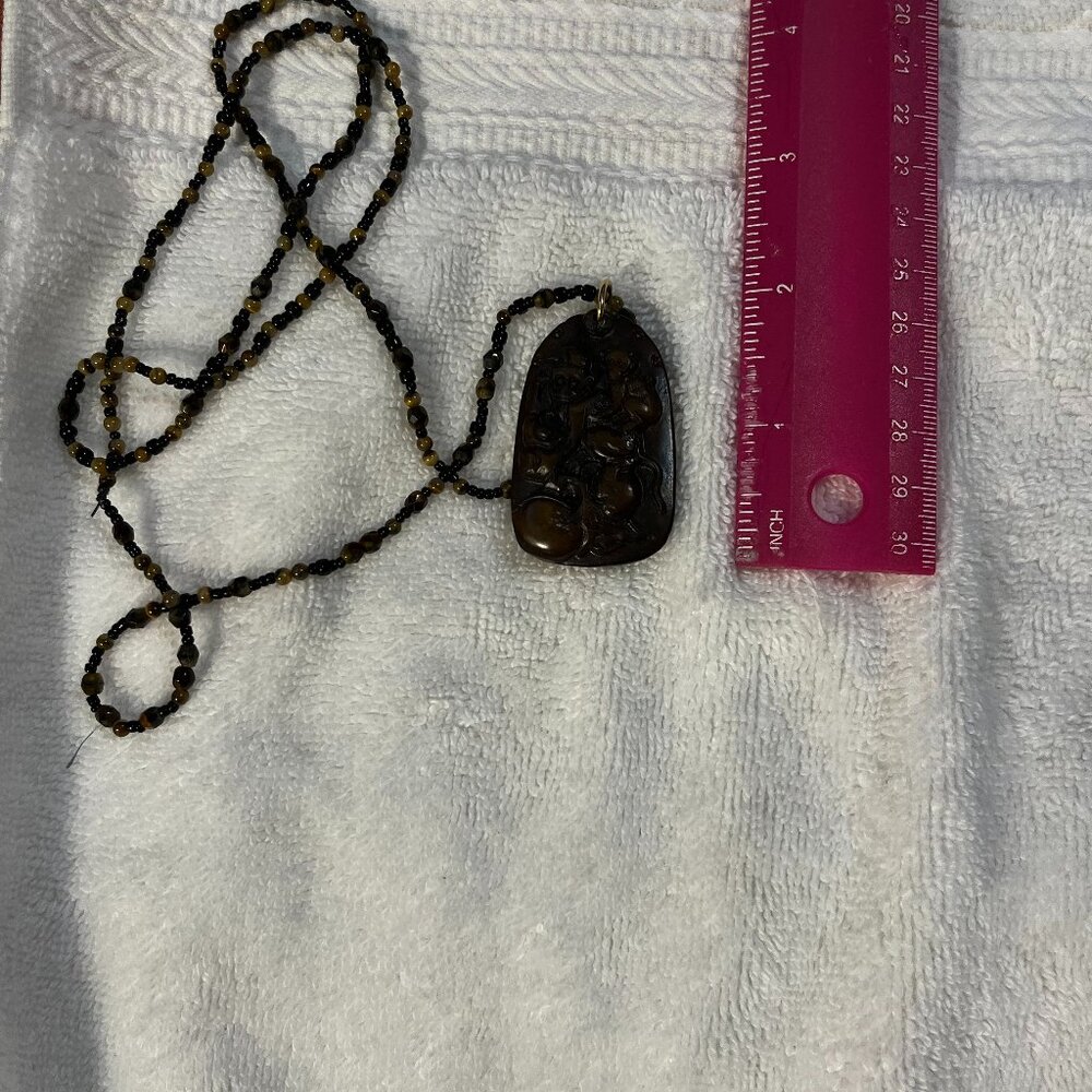Genuine brown jade pendant.